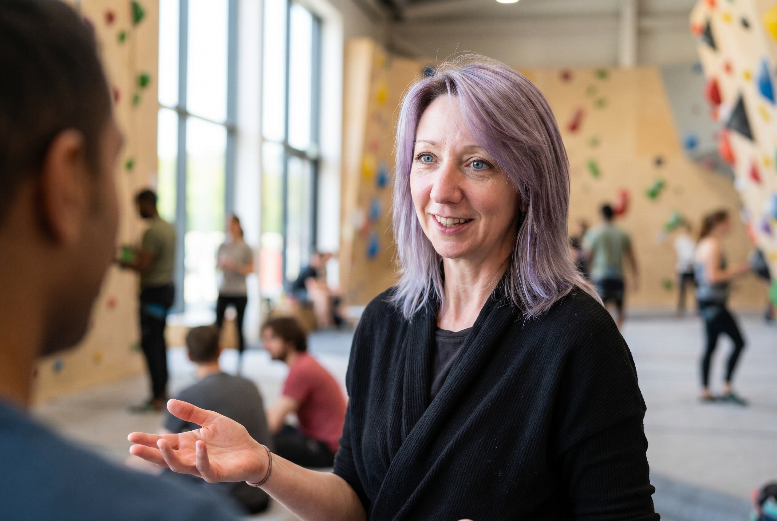Viv welcoming a member at a climbing centre